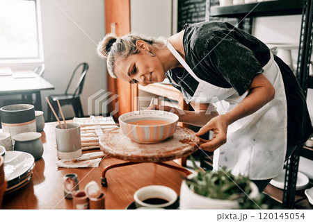 I spend time perfecting my art. Cropped shot of an attractive mature woman standing alone and painting a pottery bowl in her workshop. I spend time perfecting my art. Cropped shot of an attractive mature woman standing alone and painting a pottery bowl in her workshop. 120145054