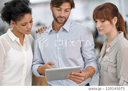 Making his point. Shot of three young business professionals having a meeting. 120145073