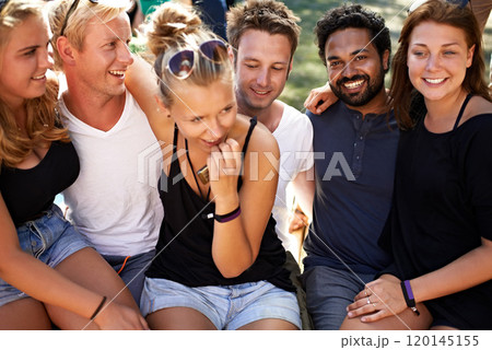 Casual and cool crew. A group of friends sitting together arm in arm. Casual and cool crew. A group of friends sitting together arm in arm. 120145155