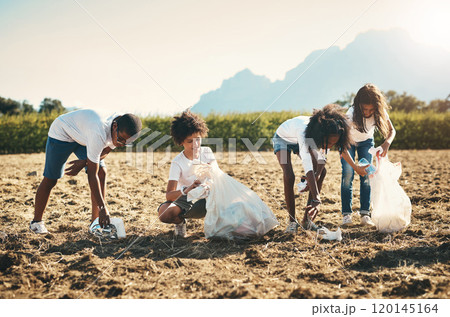 We all live here, we all need to keep it clean. Shot of a group of teenagers picking up litter off a field at summer camp. We all live here, we all need to keep it clean. Shot of a group of teenagers picking up litter off a field at summer camp. 120145164