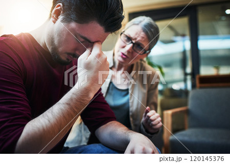 The deepest scars are the ones we dont see. Shot of a young man being comforted by his psychologist during a therapeutic session. 120145376