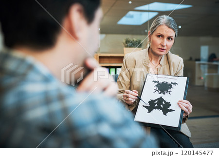 Its not as ambiguous as it seems. Shot of a mature psychologist conducting an inkblot test with her patient during a therapeutic session. Its not as ambiguous as it seems. Shot of a mature psychologist conducting an inkblot test with her patient during a therapeutic session. 120145477