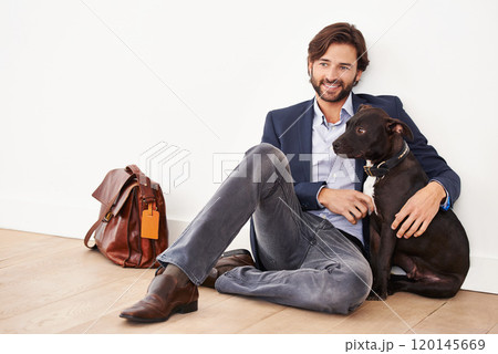 Hes my best friend. A handsome businessman sitting alongside his dog. Hes my best friend. A handsome businessman sitting alongside his dog. 120145669