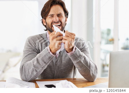 Today is not a good day. A handsome businessman crumpling paper in frustration over work stress. 120145844
