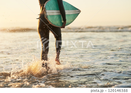 When life give you rough waves, surf them. Rearview shot of an unrecognizable young woman going surfing at the beach. 120146388