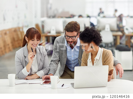 Laying down some business wisdom. Shot of a group of young office professionals talking over a digital tablet. 120146416