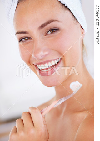 Watch out plaque. A gorgeous woman holding a toothbrush and flashing a perfect smile. Watch out plaque. A gorgeous woman holding a toothbrush and flashing a perfect smile. 120146557