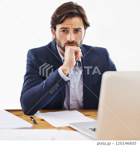 Let me think about this. Shot of a confident young businessman working on his laptop and looking at the camera. 120146605