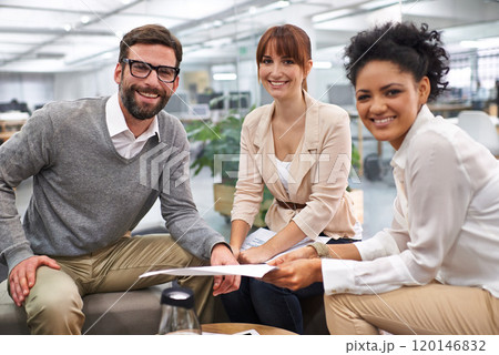 Running through the contracts details. Shot of a group of young professionals discussing paperwork. Running through the contracts details. Shot of a group of young professionals discussing paperwork. 120146832