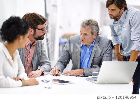 Leading his team through the creative process. Shot of a group of a diverse group of business professionals having a meeting. 120146954