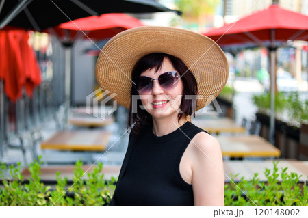 A woman resident of a metropolis in casual clothes on the street of her favorite city A woman resident of a metropolis in casual clothes on the street of her favorite city 120148002