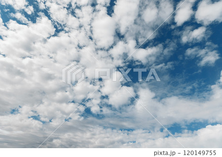 Picturesque natural landscape with an electric blue sky filled with fluffy white cumulus clouds, creating a serene atmosphere. Picturesque natural landscape with an electric blue sky filled with fluffy white cumulus clouds, creating a serene atmosphere. 120149755