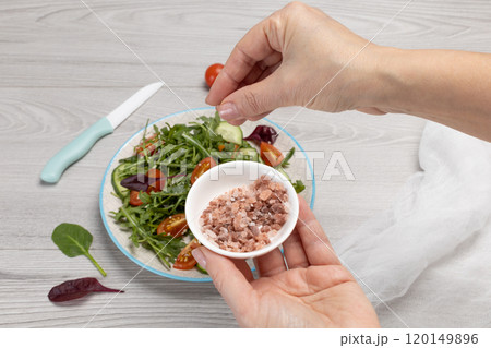 Vegetable salad of tomatoes, cucumbers, greens on the plate. Vegetable salad of tomatoes, cucumbers, greens on the plate. 120149896