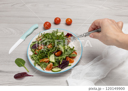 Vegetable salad of tomatoes, cucumbers, greens on the plate with olive oil. Vegetable salad of tomatoes, cucumbers, greens on the plate with olive oil. 120149900