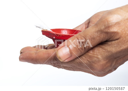 Elderly woman holding red candle on white background with clipping path 120150587
