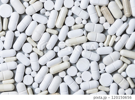 Mix of medical capsules and pills on grey top view. Taking dietary supplements and medicines Mix of medical capsules and pills on grey top view. Taking dietary supplements and medicines 120150656