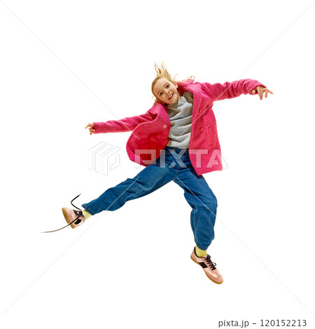 Full length photo of energetic cheerful little girl jumping raising hands against white studio background. Crazy. 120152213