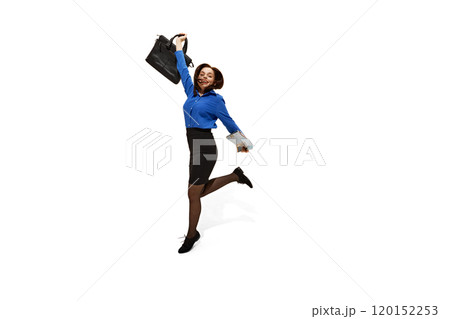 Dynamic photo of young attractive woman dressed office attire jumping raising hand with bag against white studio background. 120152253
