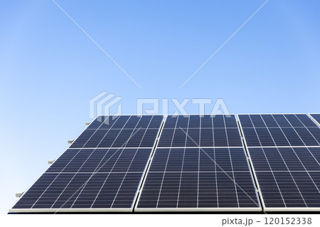 Aerial view of solar panel cells on clear blue sky background. Clean alternative energy power concept, sustainable resources. Modern house, solar panels stand-alone photovoltaic plant system on roof Aerial view of solar panel cells on clear blue sky background. Clean alternative energy power concept, sustainable resources. Modern house, solar panels stand-alone photovoltaic plant system on roof 120152338