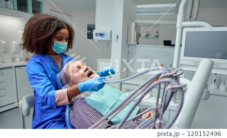 Dentist demonstrates correct brushing techniques, showing patient practical steps to maintain healthy teeth between visits. 120152496