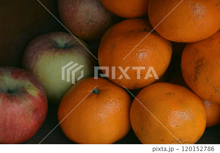 A collection of apples and oranges stacked together in a shelf, emphasizing natural colors and freshness 120152786