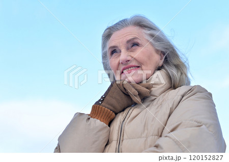 Beautiful elderly woman posing in a snowy winter park Beautiful elderly woman posing in a snowy winter park 120152827