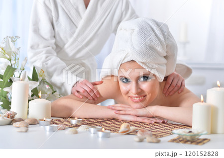 Beautiful woman in spa centar enjoying the massage. 120152828