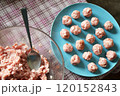 Making little meatballs at home 120152843