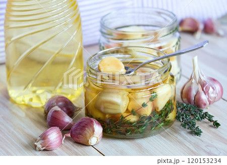 Garlic cloves pickled in sunflower oil and thyme. Garlic cloves pickled in sunflower oil and thyme. 120153234