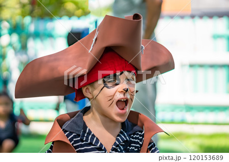 Boy Cat Pirate costume. Halloween party in kindergarten. Aqua makeup painted kids face. Bright festive Boy Cat Pirate costume. Halloween party in kindergarten. Aqua makeup painted kids face. Bright festive 120153689