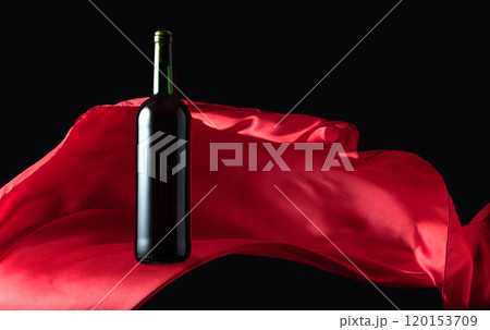 Bottle of red wine and flutters of red cloth. Bottle of red wine and flutters of red cloth. 120153709