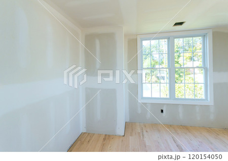 During construction, drywall is partially completed, but interior is unpainted drywall 120154050