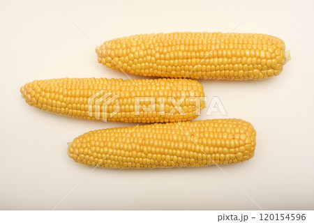 Three peeled ears of corn on a white background. A printed cob. Ripe delicious corn. Three peeled ears of corn on a white background. A printed cob. Ripe delicious corn. 120154596
