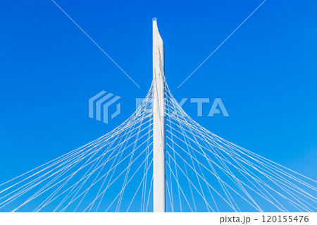 White metal cable-stayed bridge details are under blue sky White metal cable-stayed bridge details are under blue sky 120155476