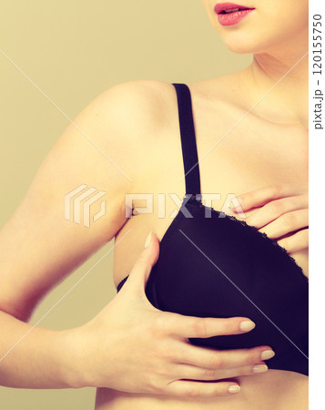 Girl getting comfortable in her bra Girl getting comfortable in her bra 120155750