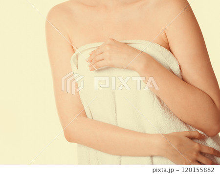 Woman covering breast under towel. 120155882