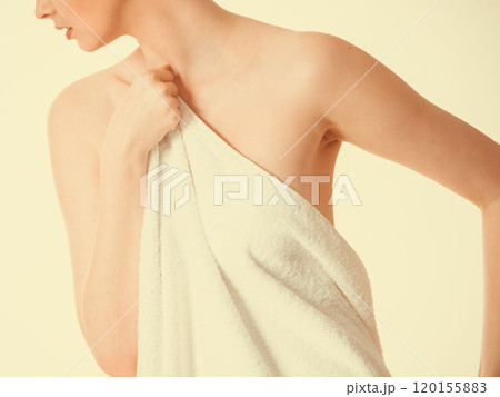 Woman covering breast under towel. 120155883