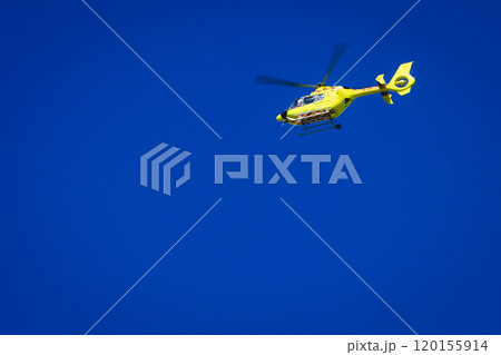 Yellow helicopter on clear dark blue sky Yellow helicopter on clear dark blue sky 120155914