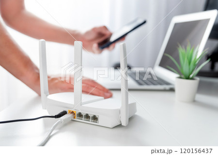 Modern wi-fi router on light table in room 120156437