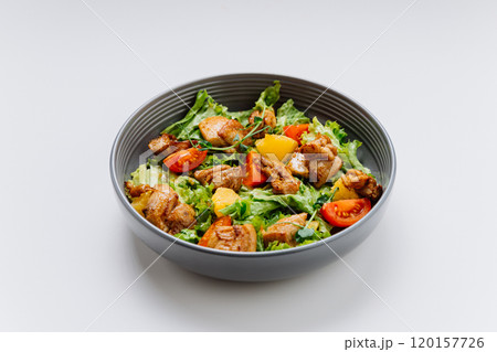 Fresh chicken salad with lettuce, cherry tomatoes, and citrus, perfect for a light and healthy meal 120157726
