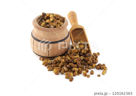 Bee bread in a rustic wooden barrel with a small wooden scoop on white background Bee bread in a rustic wooden barrel with a small wooden scoop on white background 120162365