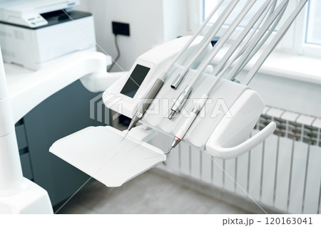 Dental equipment setup in a modern clinic with tools Dental equipment setup in a modern clinic with tools 120163041