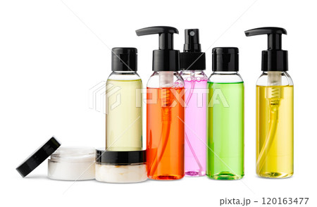 Variety of colorful personal care bottles and grooming accessories arranged on a white surface Variety of colorful personal care bottles and grooming accessories arranged on a white surface 120163477