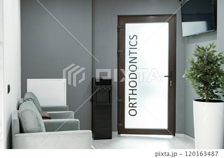 Welcoming orthodontic office with modern decor and comfortable seating area for patients Welcoming orthodontic office with modern decor and comfortable seating area for patients 120163487