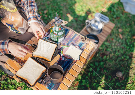キャンプの昼食を作る若い女性 120165251