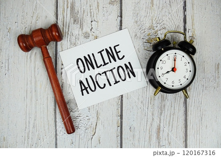 Online Auction alphabet letters with alarm clock and wooden gavel top view on wooden background Online Auction alphabet letters with alarm clock and wooden gavel top view on wooden background 120167316