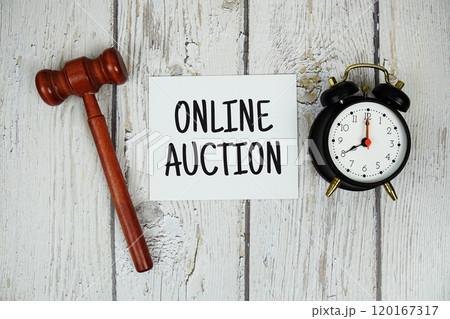 Online Auction alphabet letters with alarm clock and wooden gavel top view on wooden background Online Auction alphabet letters with alarm clock and wooden gavel top view on wooden background 120167317