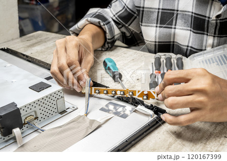 Man technician repairing television Man technician repairing television 120167399