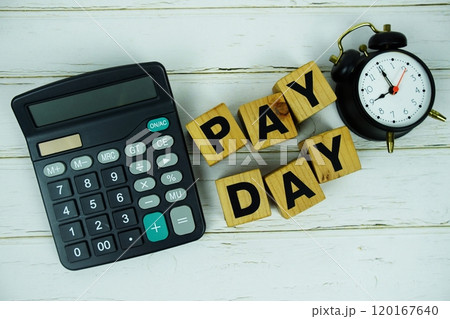 Pay Day alphabet letters with calculator and alarm clock top view on wooden background Pay Day alphabet letters with calculator and alarm clock top view on wooden background 120167640