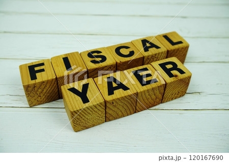 Fiscal Year with wooden blocks alphabet letters on wooden background 120167690